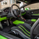 A bright green and black suede Lamborghini Huracan Tecnica interior.